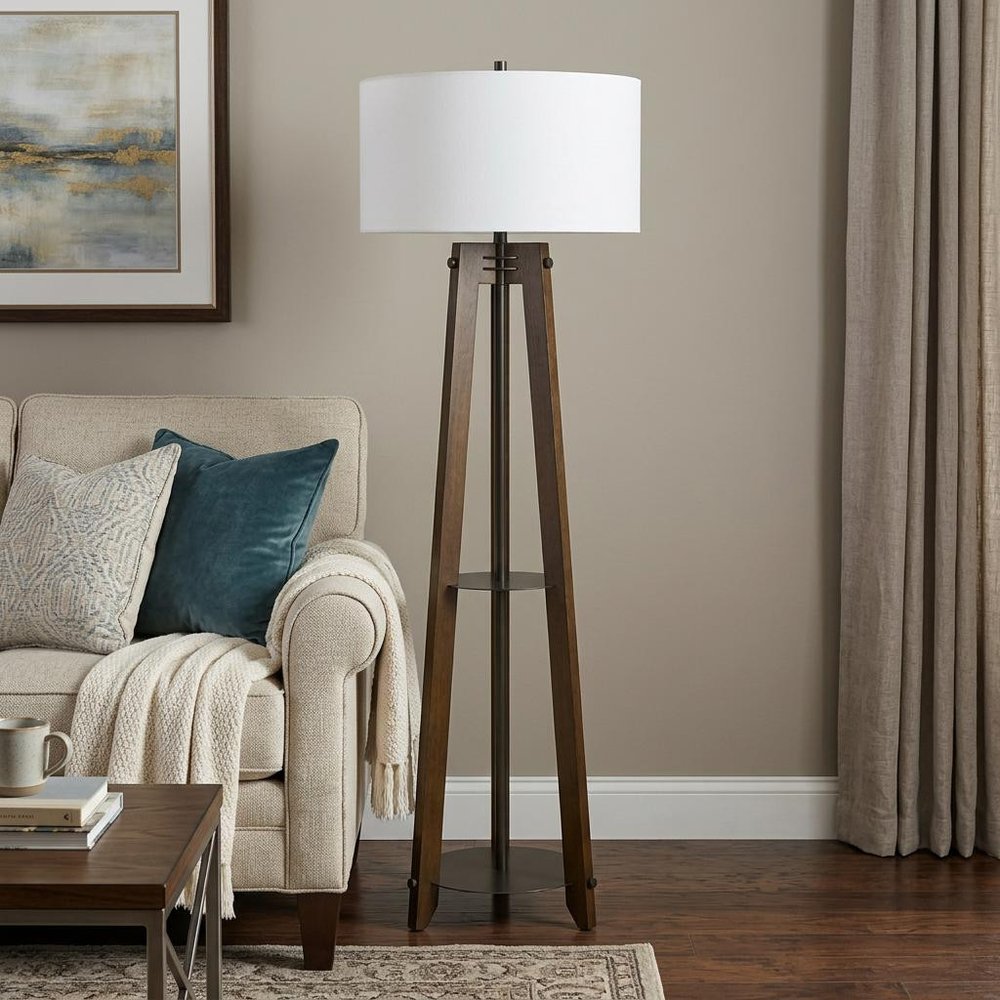65" Brown Tripod Floor Lamp With White Rectangular Shade standing in a furnished interior on a dark wood floor.