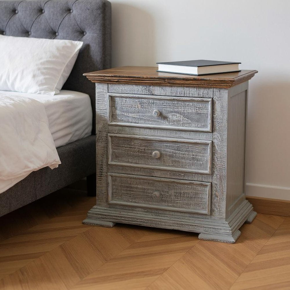 32" Gray Three Drawer Nightstand styled in a furnished interior with an off-white wall on a wood floor.