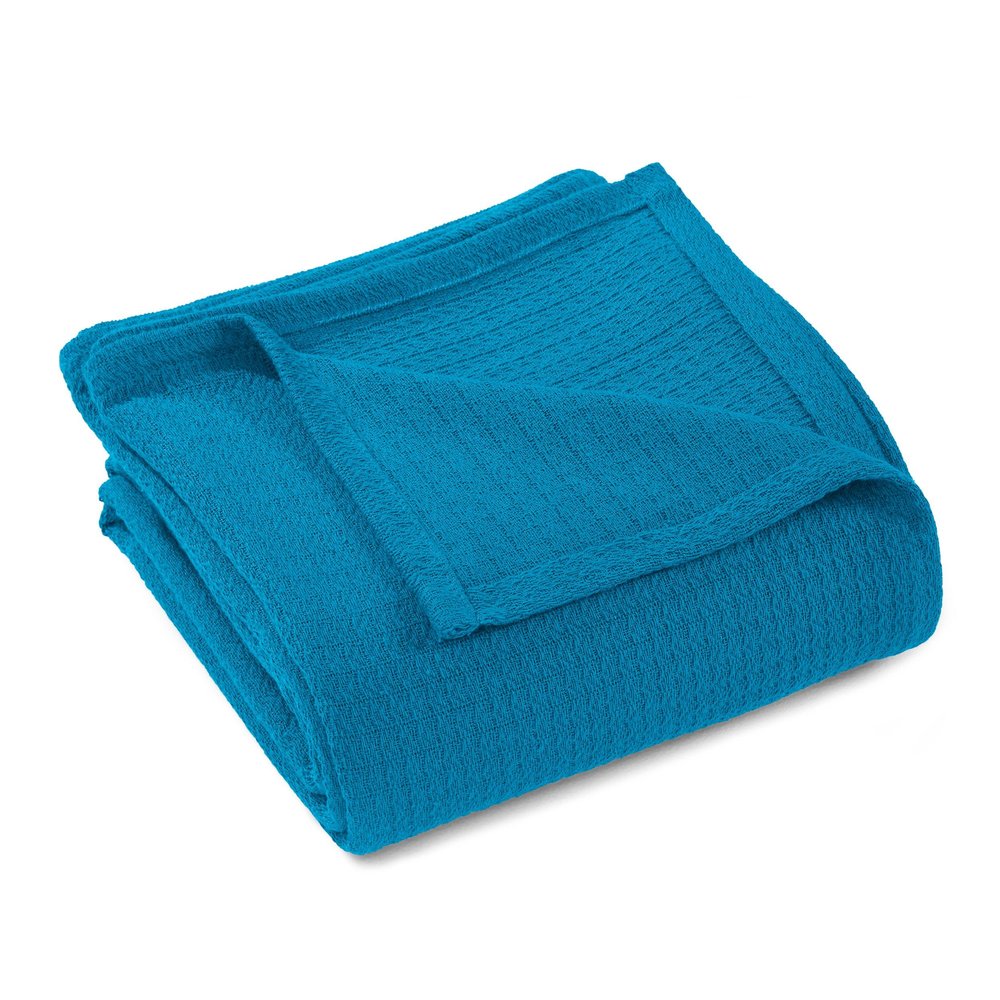 A folded azure blue cotton waffle weave blanket on a white background.