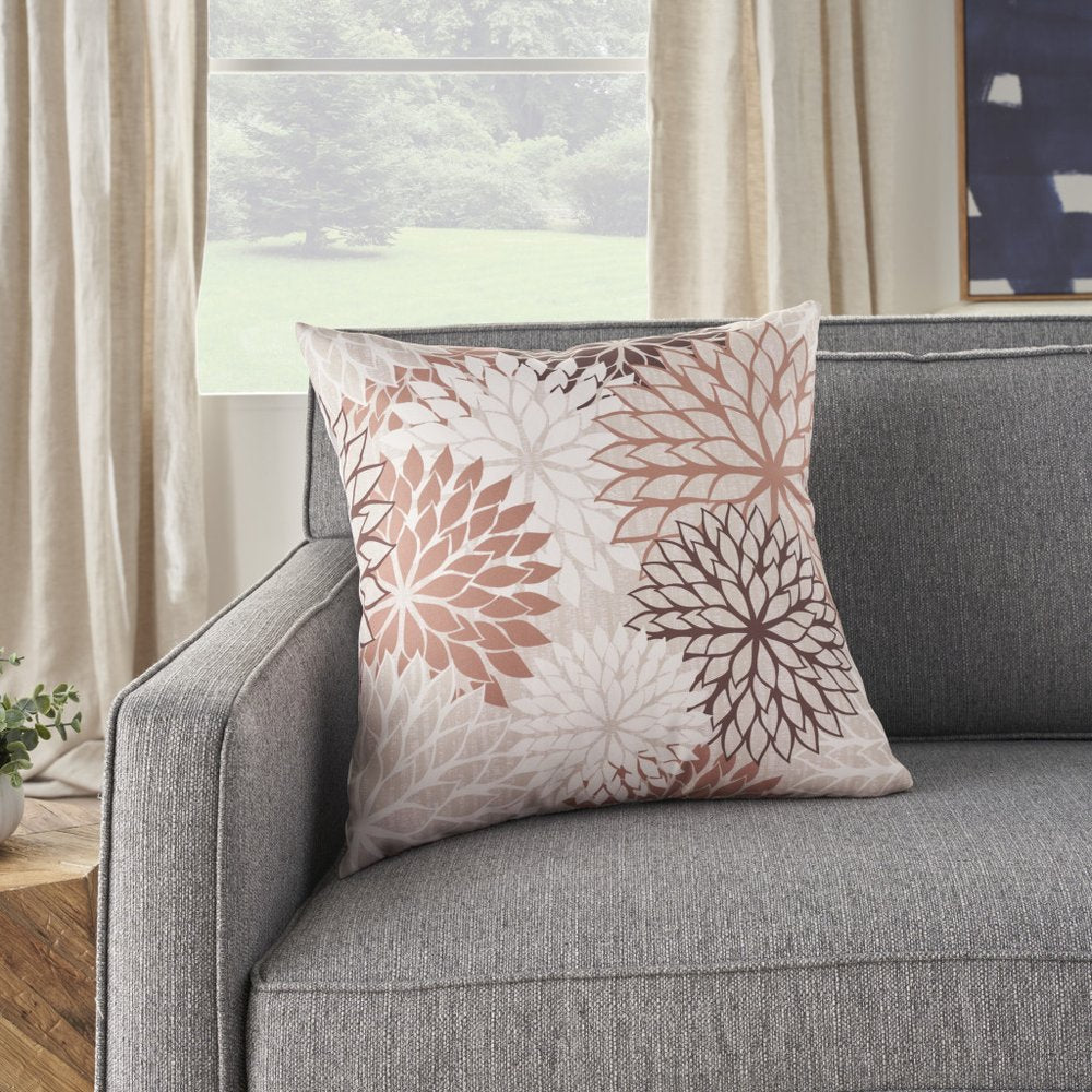 20" Brown Beige and Ivory Floral Indoor Outdoor Throw Pillow styled in a furnished interior with an off-white wall on a tiled floor.