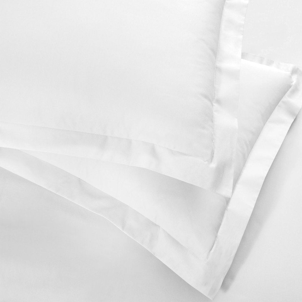 Close-up of a white king cotton blend duvet cover set, showing layered fabric and stitching.