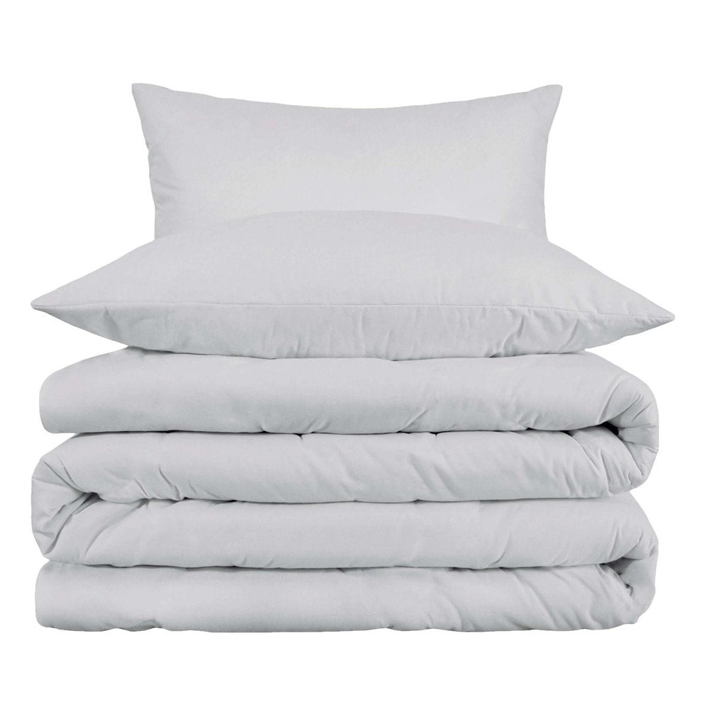 Stack of white cotton bedding, including a duvet and two pillows, on a white background.