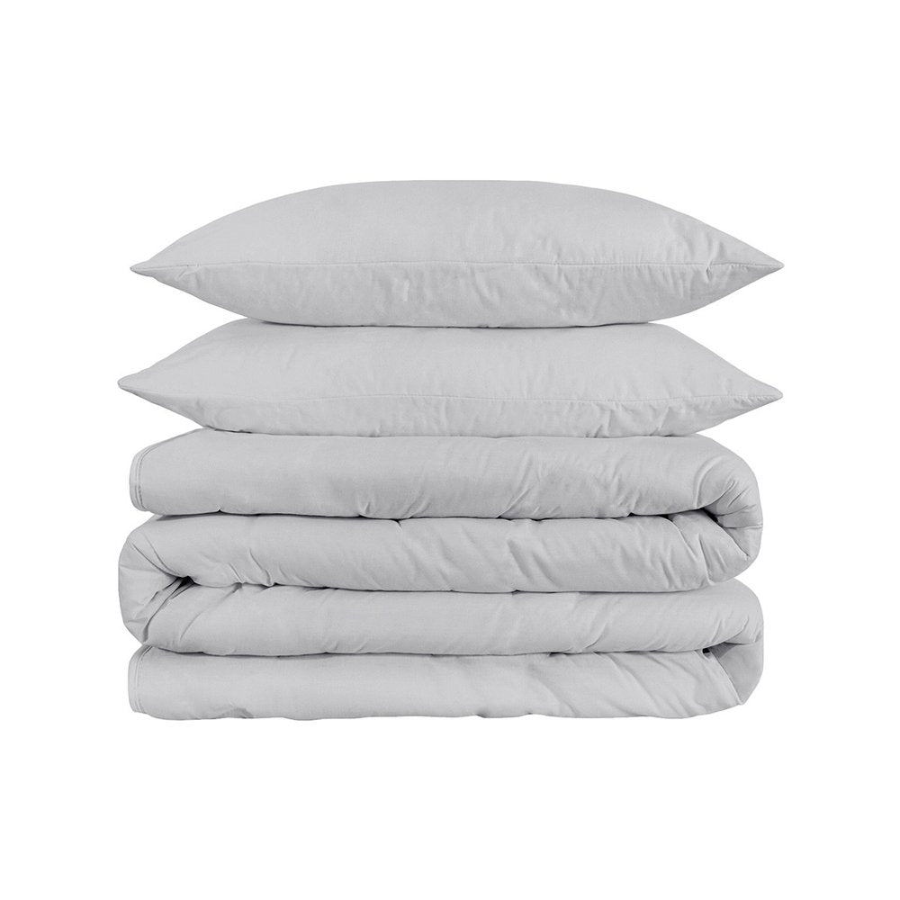 Stack of two light gray cotton pillows and a folded light gray cotton duvet cover on a white background.