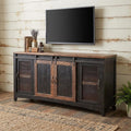 60" Black Solid Wood Cabinet Enclosed Storage Distressed TV Stand styled in a furnished interior with an off-white wall on a wood floor.