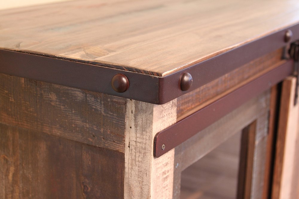 Close-up of a brown solid wood TV stand with metal accents and visible wood grain.