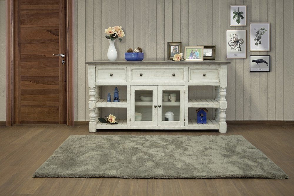 Ivory distressed solid wood TV stand with open shelving and glass-front cabinets on a wood floor with a gray rug.