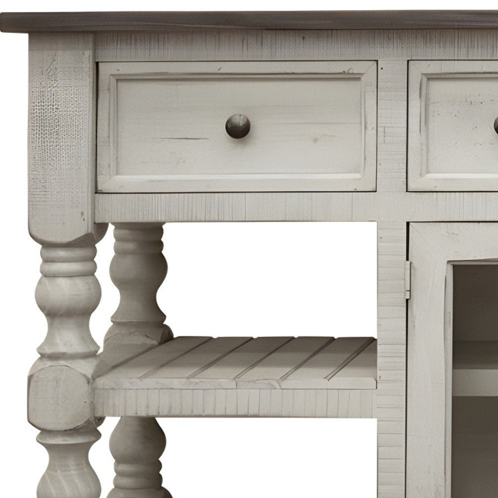 Close-up of an ivory distressed solid wood TV stand with drawers and open shelves.