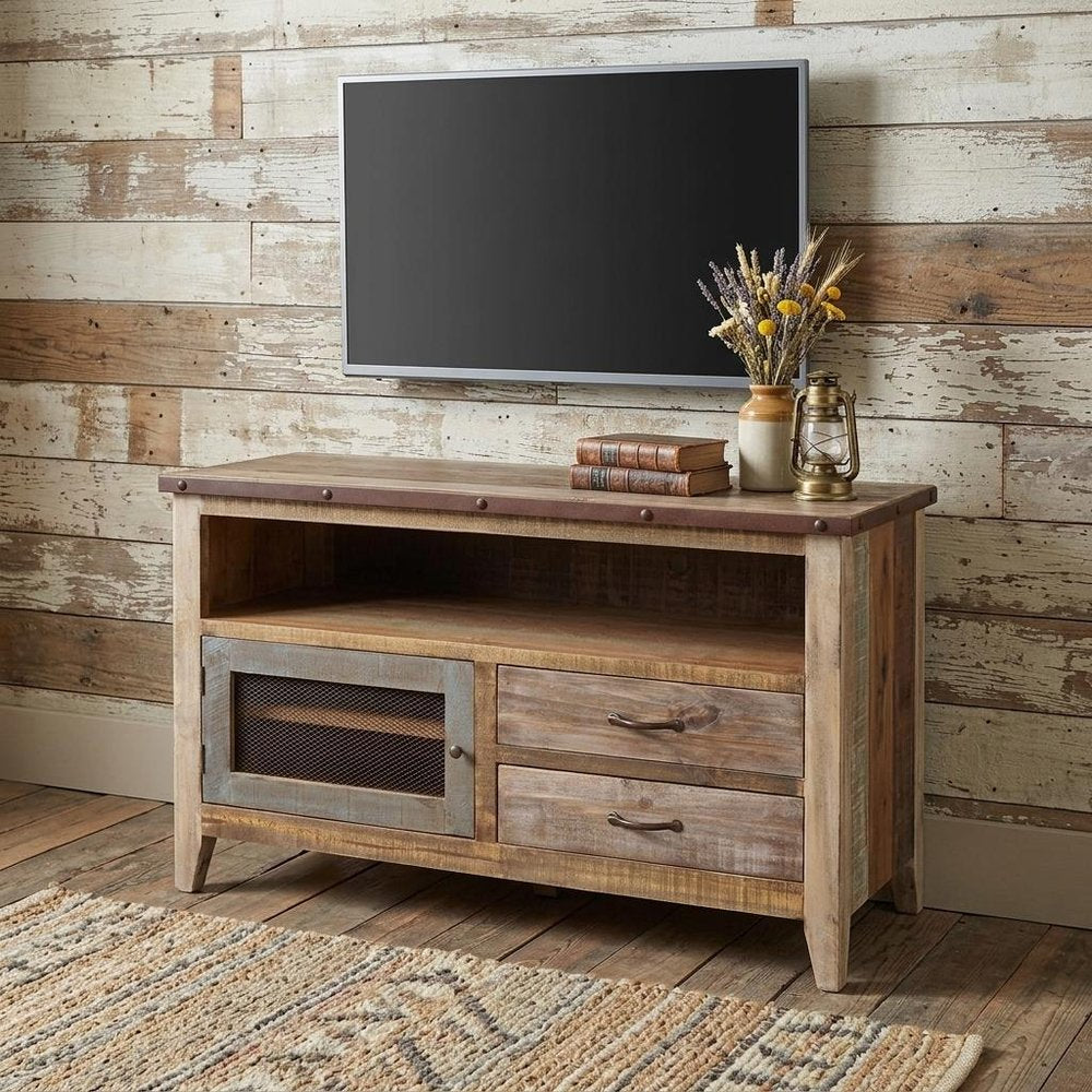 53" Brown Solid Wood Cabinet Enclosed Storage Distressed TV Stand styled in a furnished interior with a tan wall on a wood floor.