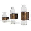 Set of Three Clear and Bronze Hammered Cylinder Metal and Glass Table Vase on a white background