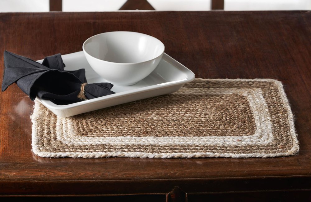19" Set of Four Natural And Ivory Geometric Braided Jute Placemats photographed against a dark studio background.