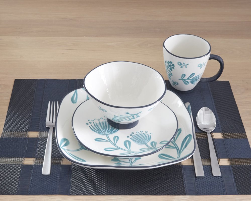 Blue and White Sixteen Piece Round Floral Ceramic Service For Four Dinnerware Set in a home interior