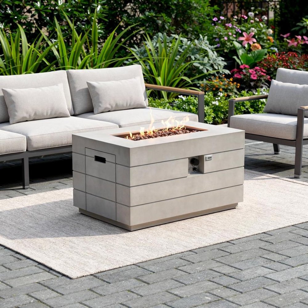 28" Gray Aluminum Natural gas Rectangular Fire pit table With Cover shown outdoors on a tiled patio with greenery.