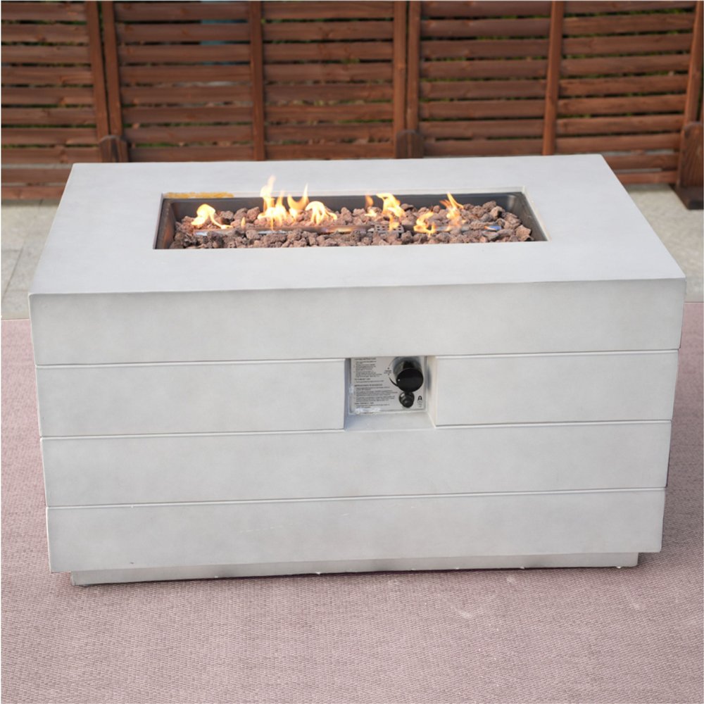 28" Gray Aluminum Natural gas Rectangular Fire pit table With Cover styled in a furnished interior with a dark brown wall on a blush floor.