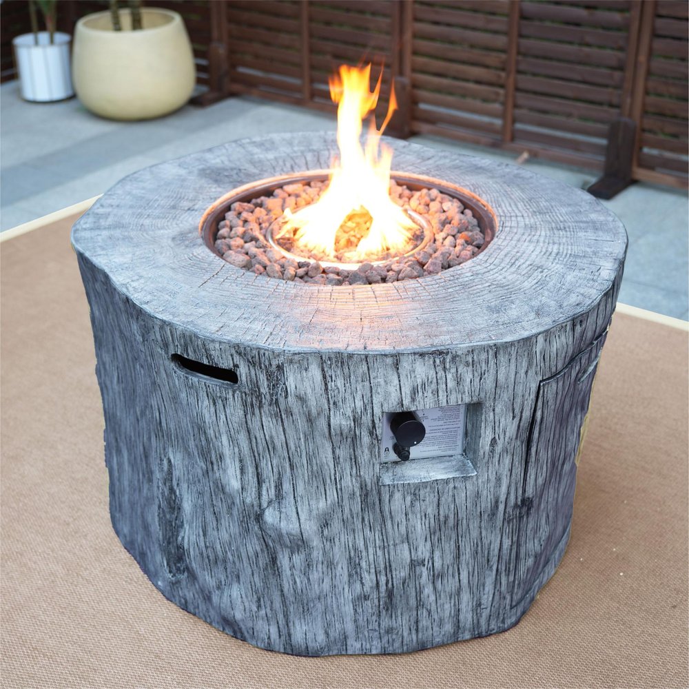 50000 BTU 40" Gray Aluminum Natural Gas Round Fire Pit Table With Cover shown outdoors on a patio.