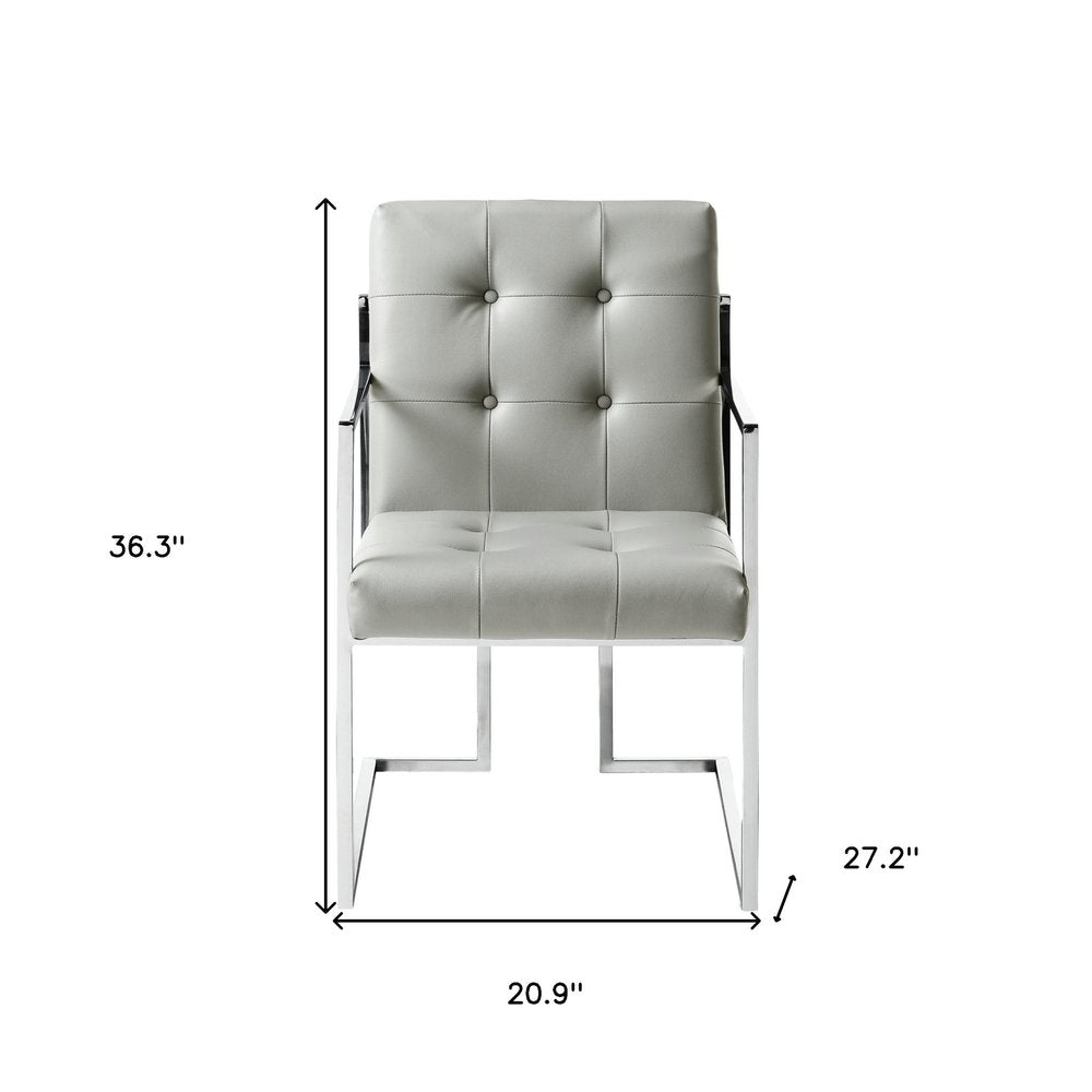 Set of Two Tufted Light Gray and Silver Metallic Upholstered Faux Leather Dining Arm Chairs on a white background