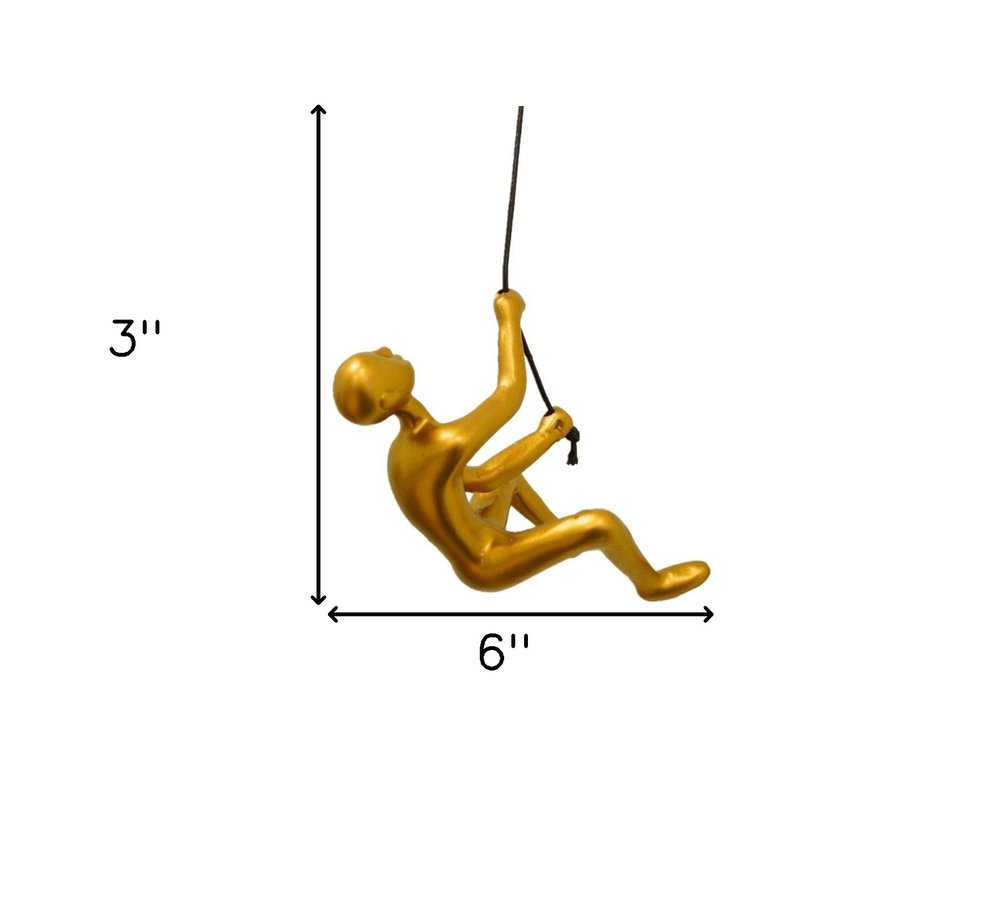 Set of Two Gold Resin Climbing Man Hanging Dimensional Sculpture on a white background