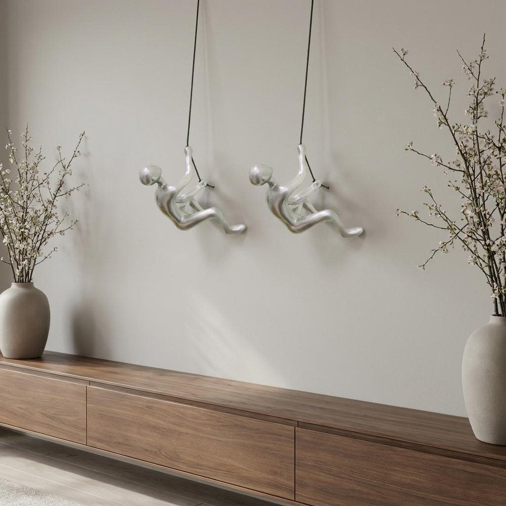 Set of Two Silver Resin Climbing Man Hanging Dimensional Sculpture in a home interior