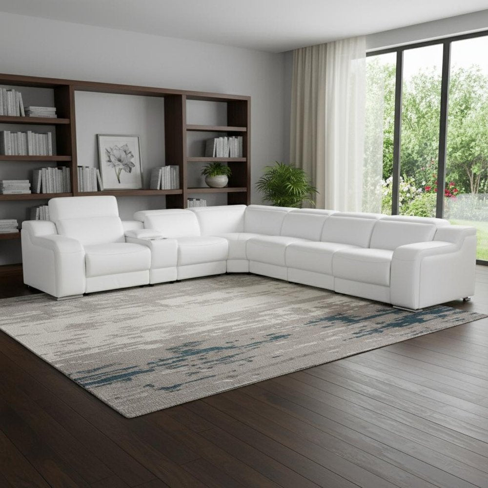 White Italian leather 4 power reclining seats L shaped Seven Piece Corner Sectional With Console in a home interior