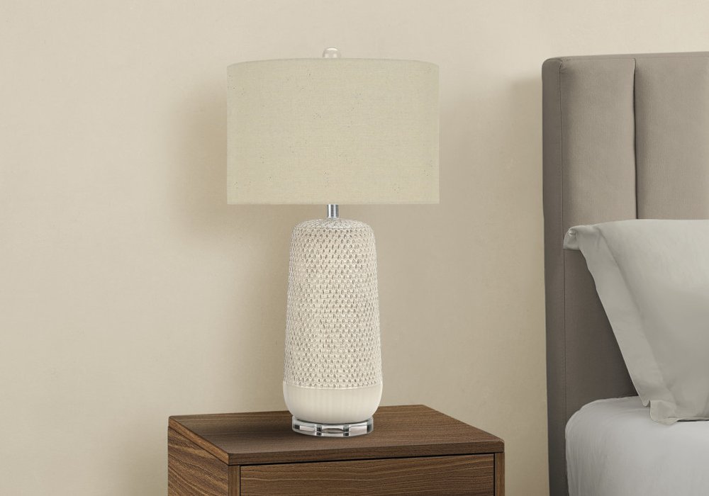 Close-up of 31" Cream Ceramic Geometric Table Lamp With Beige Drum Shade showing the cream ceramic texture.