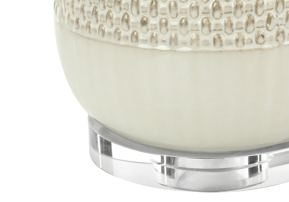 31" Cream Ceramic Geometric Table Lamp With Beige Drum Shade. Table lamp isolated on a plain white background, in a cream ceramic finish.