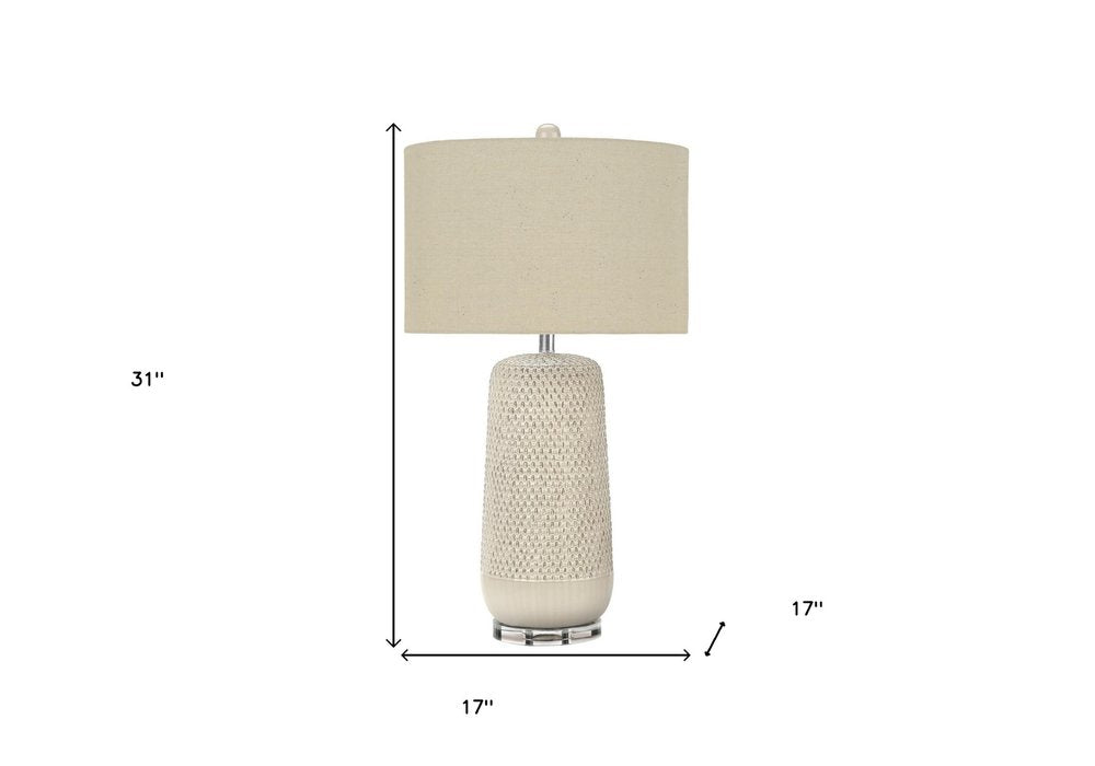 31" Cream Ceramic Geometric Table Lamp With Beige Drum Shade. Table lamp isolated on a plain white background, showing a cream ceramic surface.
