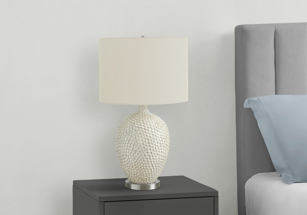 28" White and Silver Ceramic Round Table Lamp With Cream Drum Shade. Table lamp isolated on a plain white background, finished in cream ceramic.