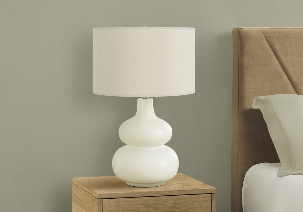 25" Cream Ceramic Gourd Table Lamp With Cream Drum Shade. Table lamp in cream ceramic.