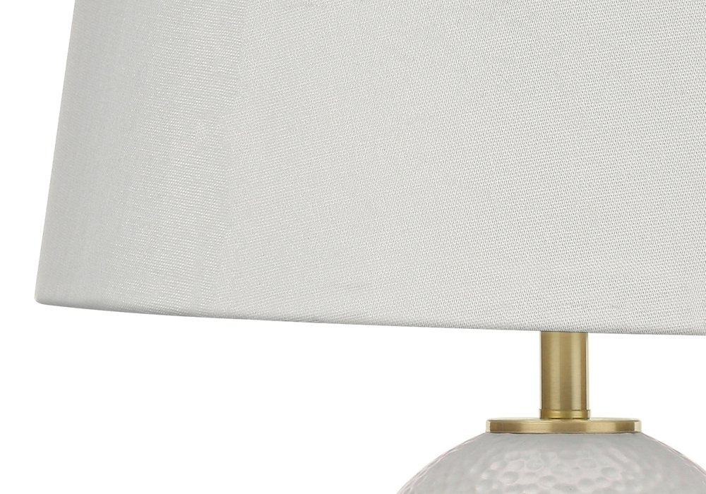 26" Gold and White Ceramic Urn Table Lamp With Cream Empire Shade. Table lamp isolated on a plain white background, showing a cream ceramic surface.