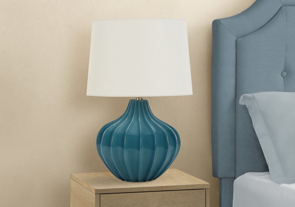 24" Blue Ceramic Gourd Table Lamp With Cream Empire Shade shown outdoors on an outdoor setting.