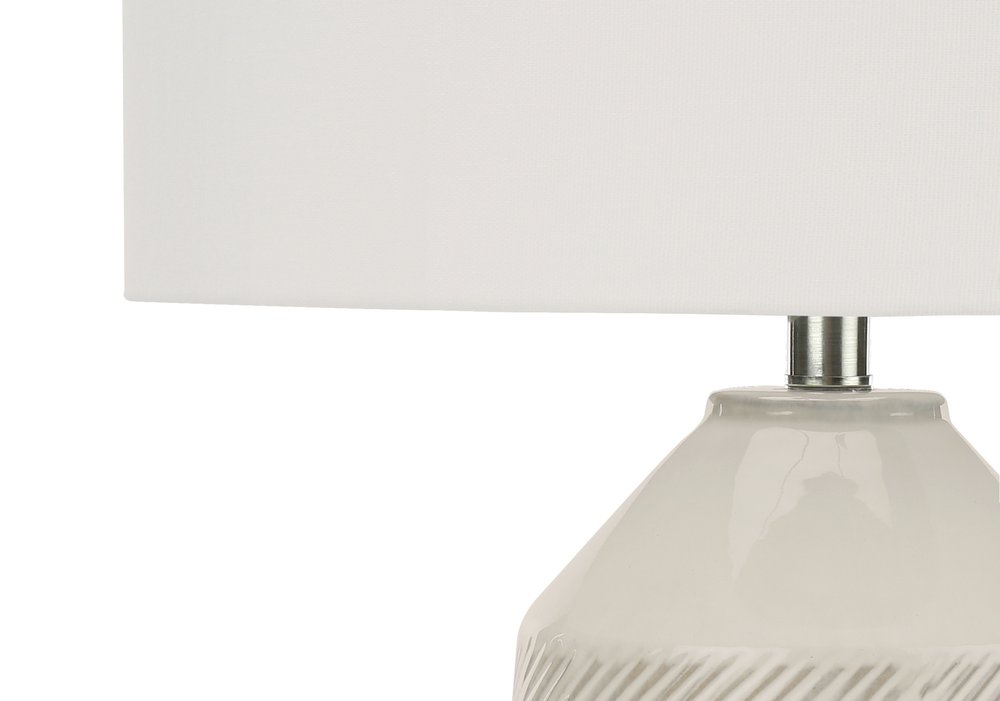33" Ivory Ceramic Geometric Table Lamp With Cream Drum Shade. Table lamp isolated on a plain white background, showing a ivory ceramic surface.