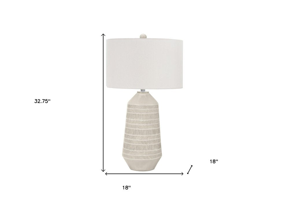 33" Ivory Ceramic Geometric Table Lamp With Cream Drum Shade. Table lamp isolated on a plain white background, showing a ivory ceramic surface.