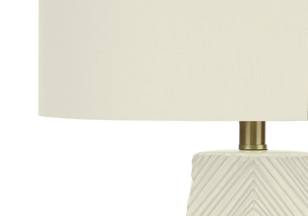 29" White Ceramic Geometric Table Lamp With Ivory Drum Shade. Table lamp isolated on a plain white background, showing a ivory ceramic surface.