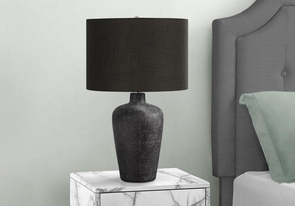 Close-up of 24" Black Ceramic Round Table Lamp With Black Drum Shade showing the black ceramic texture.