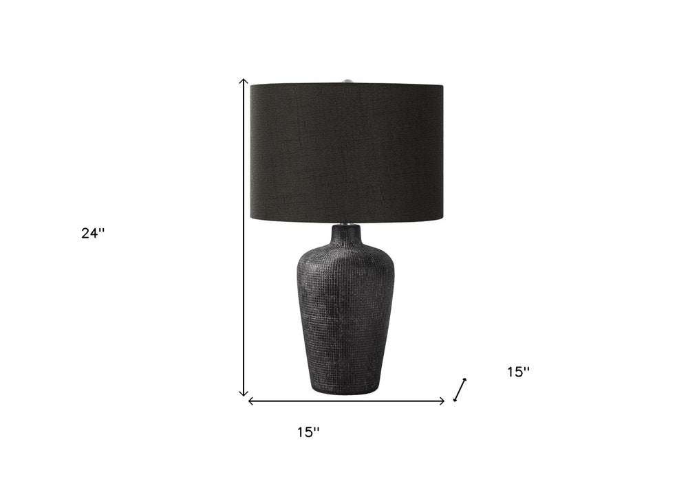 24" Black Ceramic Round Table Lamp With Black Drum Shade. Table lamp isolated on a plain white background, showing a black ceramic surface.
