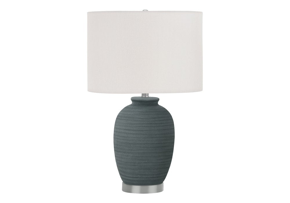 24" Blue and Silver Ceramic Round Table Lamp With Ivory Drum Shade. Table lamp isolated on a plain white background, showing a ivory ceramic surface.