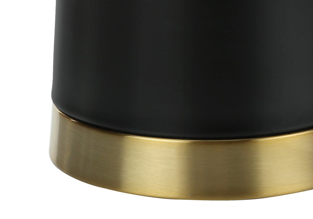 28" Black and Gold Metal Cylinder Table Lamp With Beige Drum Shade. Table lamp isolated on a plain white background, in a black metal finish.