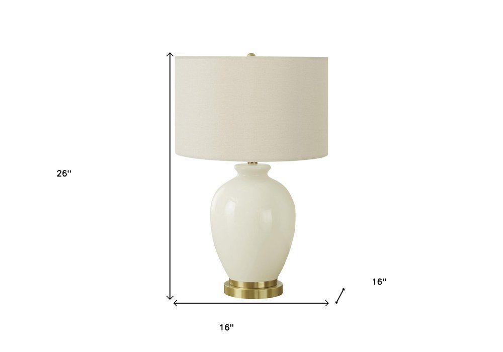 26" Gold and Ivory Ceramic Urn Table Lamp With Cream Drum Shade. Table lamp isolated on a plain white background, showing a ivory ceramic surface.