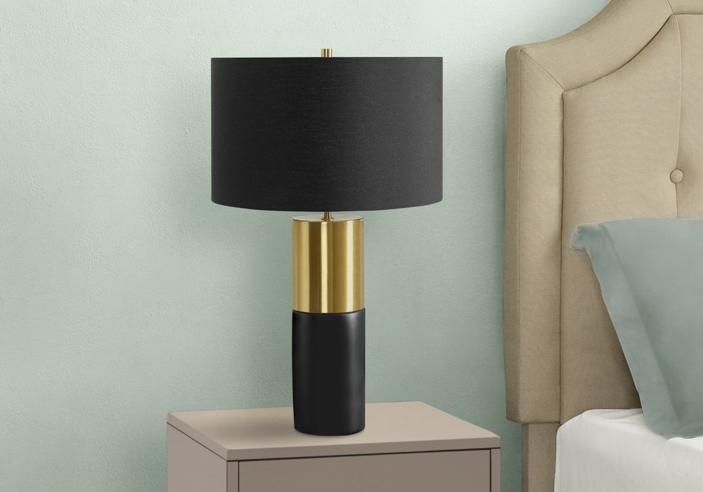 25" Black and Gold Concrete Cylinder Table Lamp With Black Drum Shade. Table lamp isolated on a plain white background, showing its gold color.
