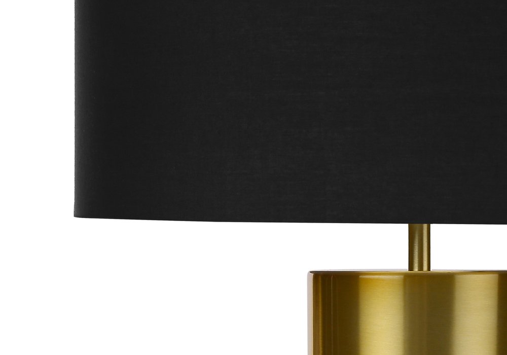25" Black and Gold Concrete Cylinder Table Lamp With Black Drum Shade photographed against a dark studio background in black.