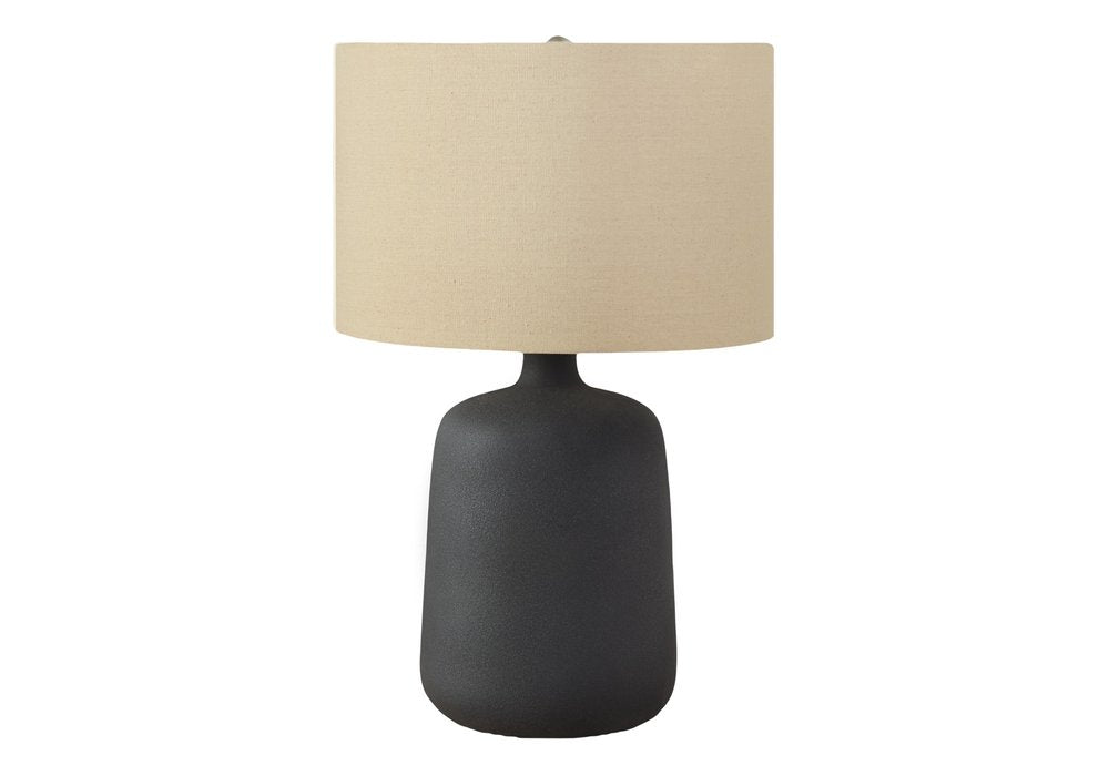 24" Black Ceramic Round Table Lamp With Beige Drum Shade. Table lamp isolated on a plain white background, finished in beige ceramic.