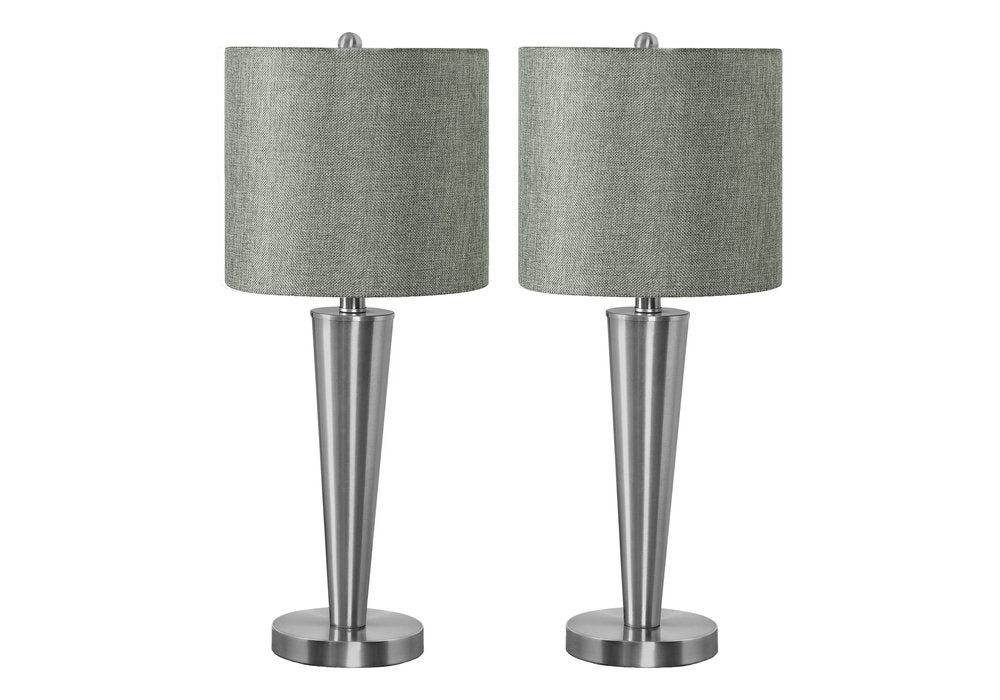 Two silver metal candlestick table lamps with gray drum shades on a white background.