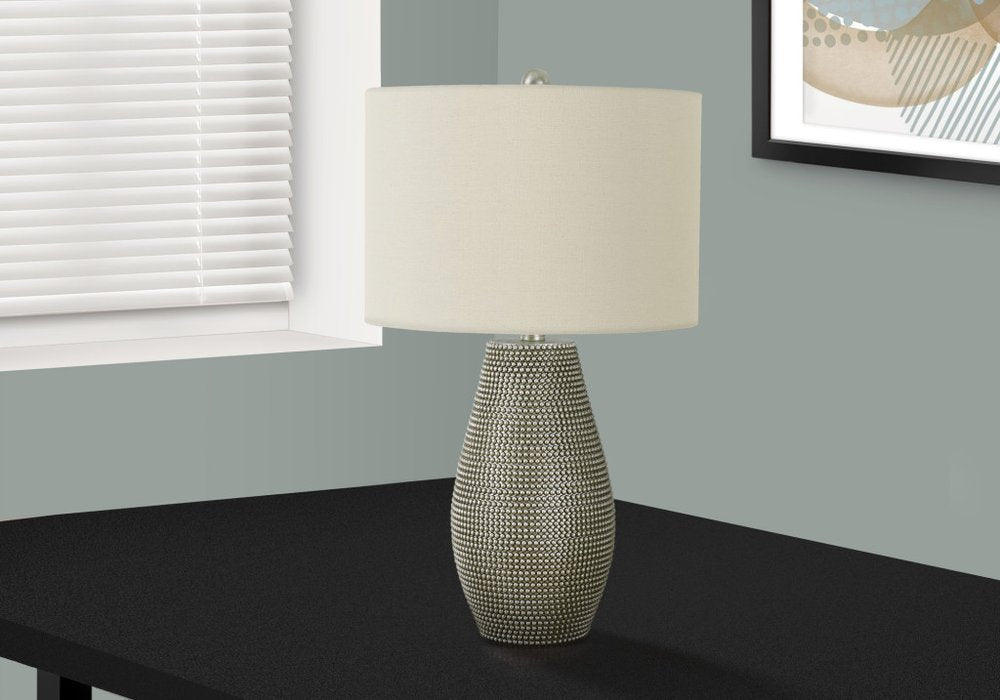 24" Gray Round Table Lamp With Ivory Drum Shade photographed against a dark studio background in ivory.