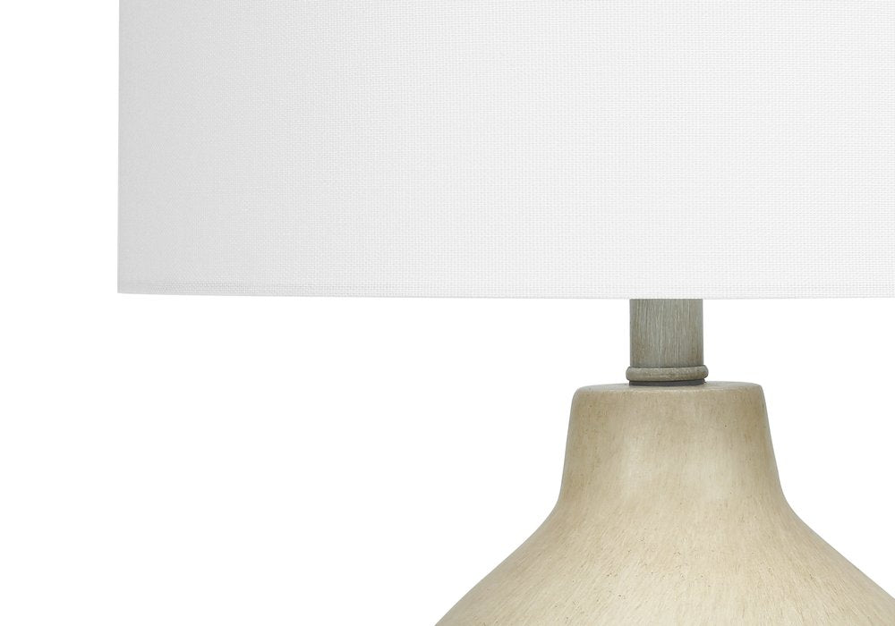 24" Beige Concrete Urn Table Lamp With Ivory Drum Shade. Table lamp isolated on a plain white background, showing its ivory color.