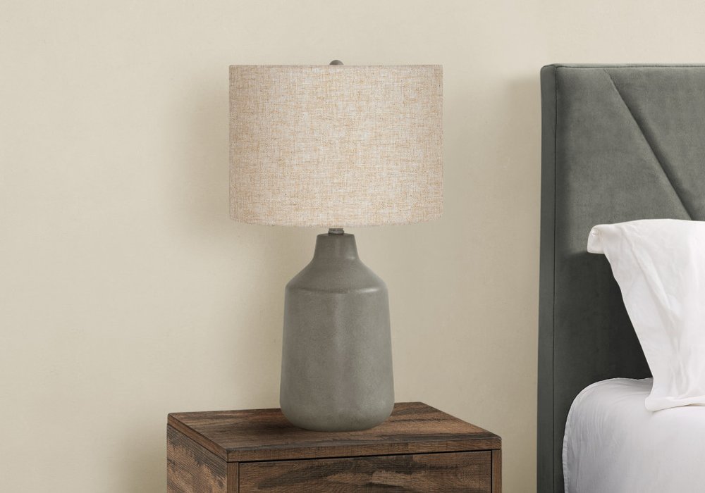 Detail view of 24" Gray Concrete Urn Table Lamp With Beige Drum Shade, filling the frame with the beige texture.