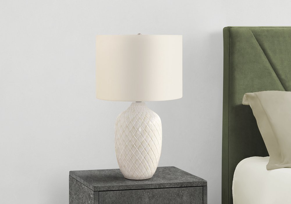 Detail view of 25" Cream Ceramic Urn Table Lamp With Cream Drum Shade, filling the frame with the cream ceramic texture.