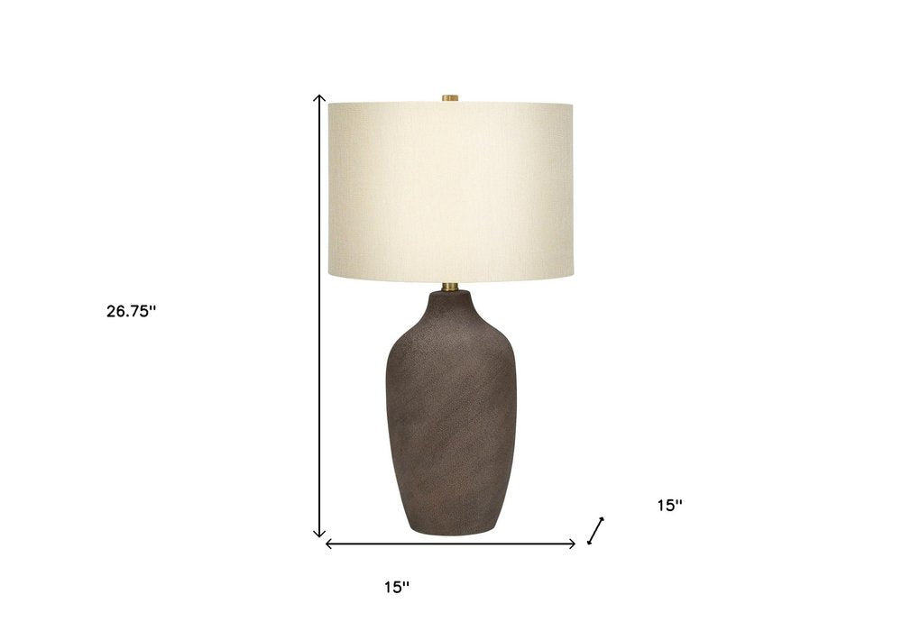 27" Gray Ceramic Urn Table Lamp With Beige Drum Shade. Table lamp isolated on a plain white background, showing a beige ceramic surface.