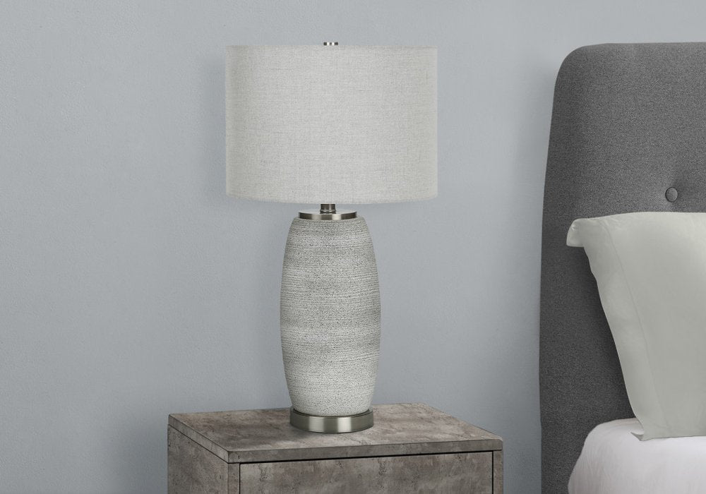 Detail view of 25" Gray and Silver Ceramic Cylinder Table Lamp With Gray Drum Shade, filling the frame with the silver ceramic texture.