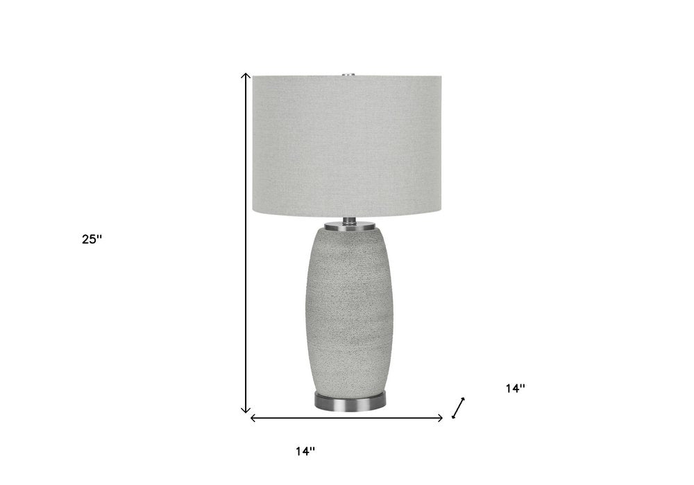 25" Gray and Silver Ceramic Cylinder Table Lamp With Gray Drum Shade. Table lamp isolated on a plain white background, finished in silver ceramic.