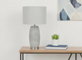 25" Gray and Silver Ceramic Cylinder Table Lamp With Gray Drum Shade. Table lamp in silver ceramic.