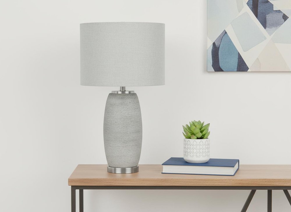 25" Gray and Silver Ceramic Cylinder Table Lamp With Gray Drum Shade. Table lamp in silver ceramic.